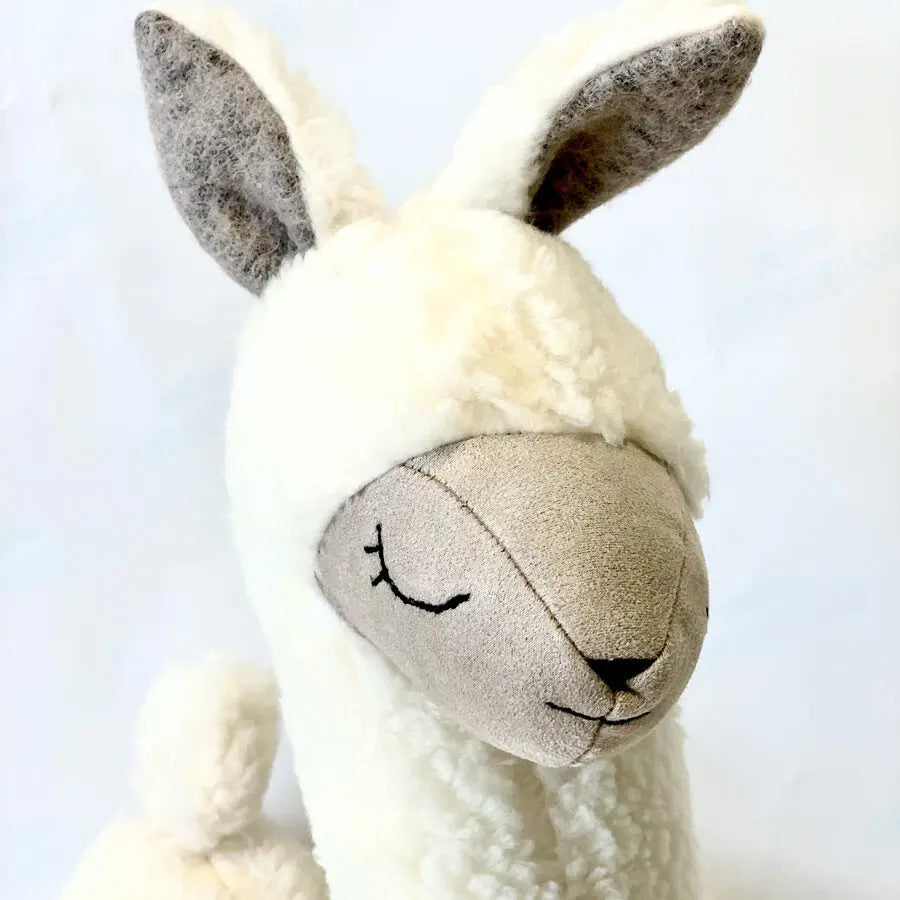 Soft Toy-Pillow Alpaca in Cream, a handmade plush toy with vegan fur, hypoallergenic for kids, multi-purpose as a headrest, comforting bedtime buddy, and decorative accent.