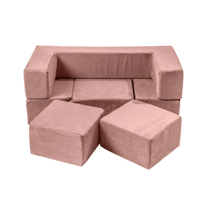 A pink couch surrounded by four cubes, showcasing the Velvet Bricks Set - a versatile playground for children. Soft, safe, and educational for active play and creativity.