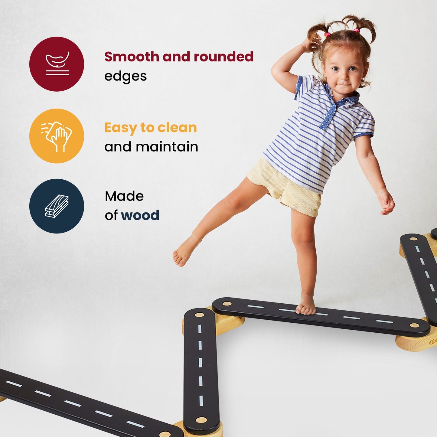 Girl stands on a bridge with a Wooden Balance Beam - 6 Elements, showcasing the educational path's natural pine wood structure and milled graphics for learning.