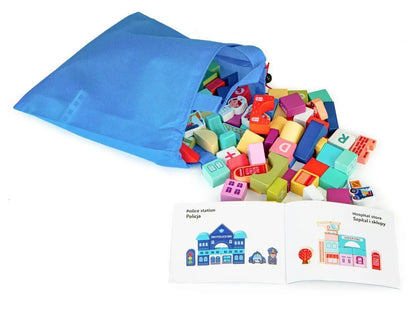 Wooden Blocks + Base City Set, 121 Pieces: A bag filled with blocks and a book, showcasing a blue bag with toys, a book with a fireman and police car, pink block, and more.