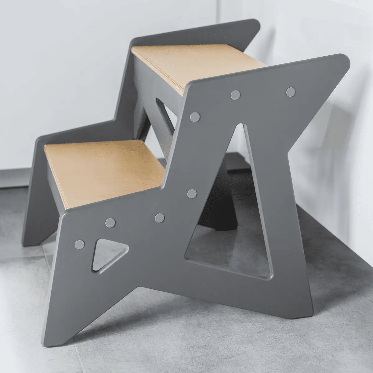 A versatile Wooden Step Stool crafted from durable plywood, designed for daily use. Dimensions: 40 x 38 x 40 cm, Step Height: 17 cm, Weight: Around 3 kg. Supports up to 100 kg. Made in Europe.