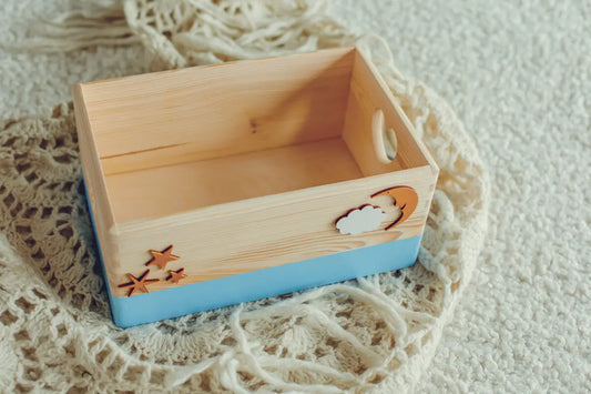 Handmade wooden storage box with cut out hearts on both sides, available in light blue. Ideal for storing keepsakes, featuring a charming design for any room. Dimensions: 20 x 30 x 13 cm.