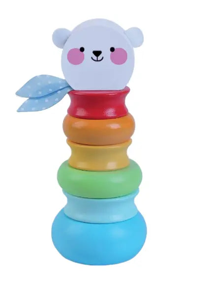 A wooden toy playset featuring a stack of colorful rings, a toy on a white background, and a blue paper leaf with white dots. Encourages motor skills, creativity, and logical thinking in children.