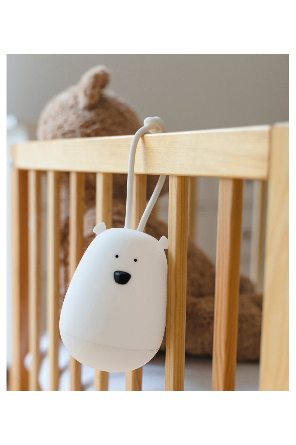 A white Hanging Night Light with Remote, featuring a silicone fastener and soft touch, designed for children's safety and comfort. Dimensions: 13 x 9.5 x 9.5 cm.