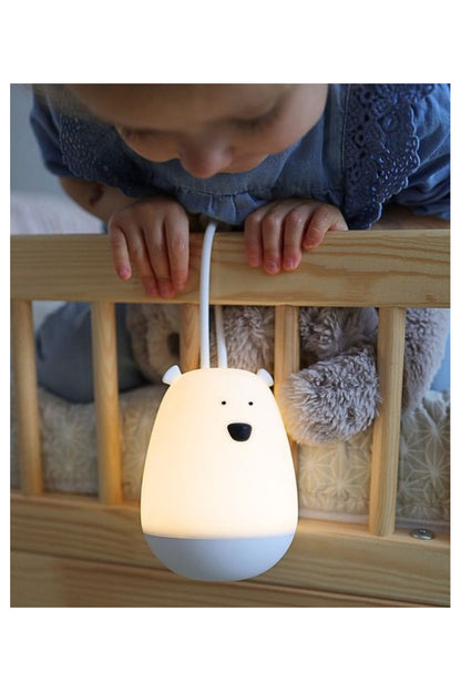 A baby's hands holding a Hanging Night Light with Remote, featuring a soft, touch-friendly silicone design. Ideal for comforting children at night.