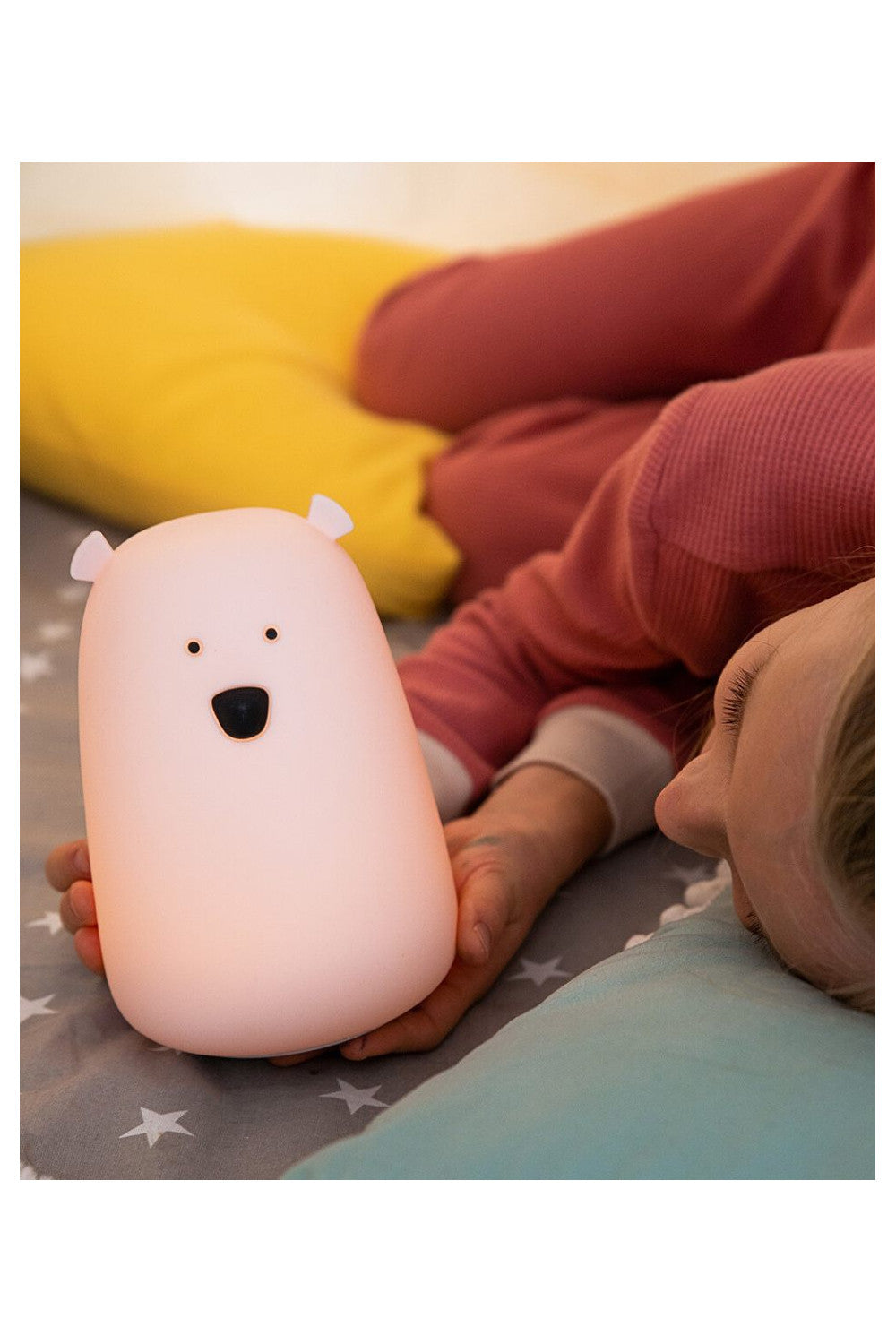 A white silicone lamp shaped like a teddy bear with protruding ears, piercing eyes, and a round belly. Soft, touchable, and portable, perfect for bedtime routines and comforting children.