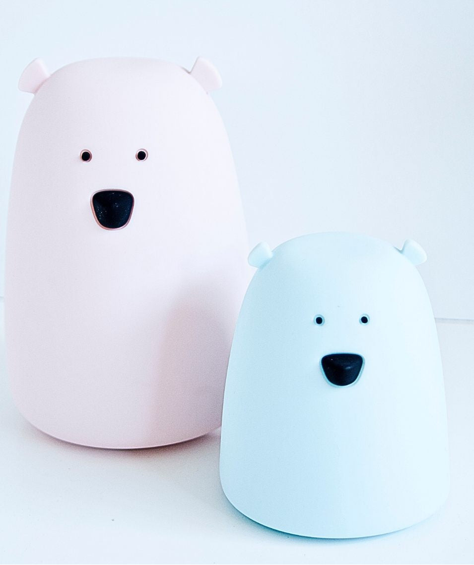 A white silicone lamp in the shape of a friendly bear, soft to the touch, tap-operated, with colorful light options, battery-powered, and safe for children.