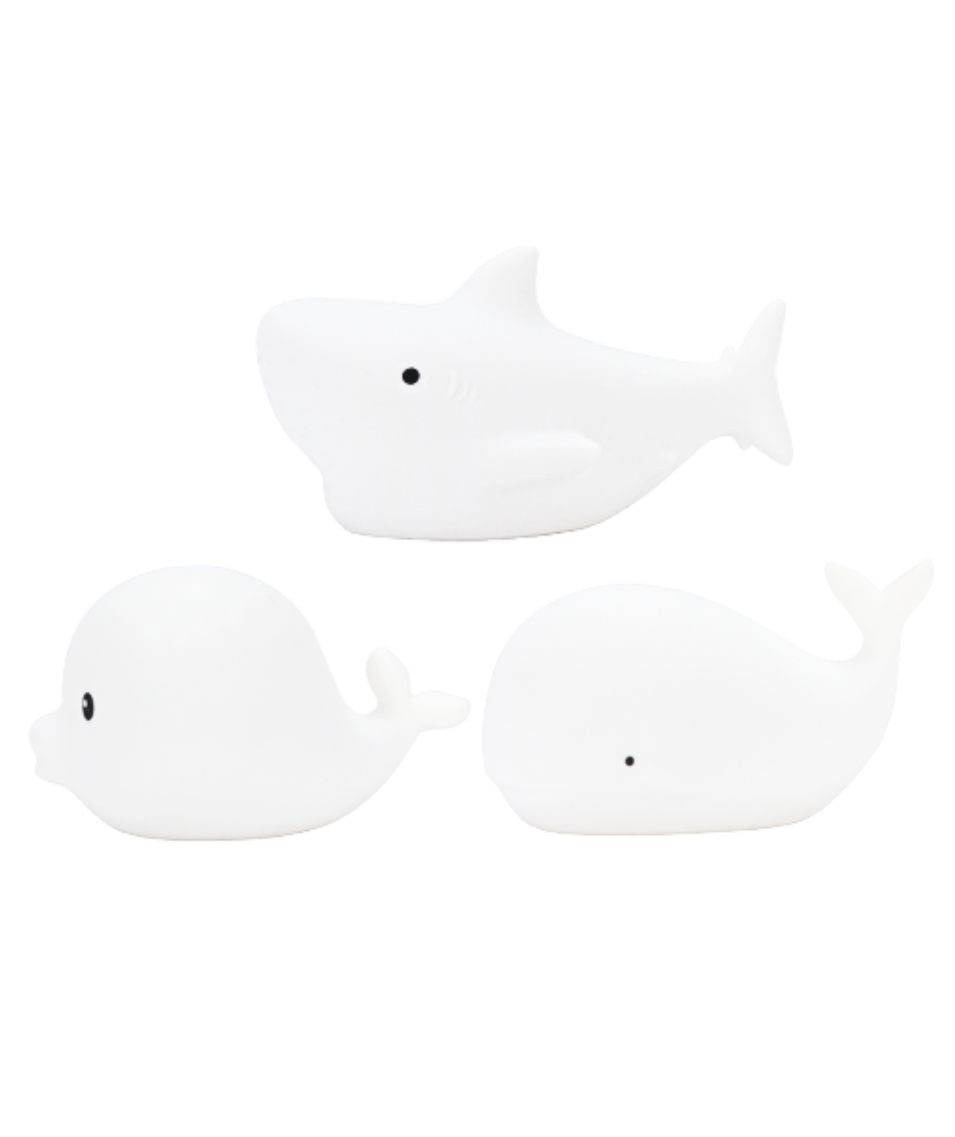 Three waterproof mini marine silicone lamps in dolphin, whale, and shark shapes. Soft silicone skin, color-changing light, and IP67 waterproof rating. Ideal for kids' rooms and bath time.