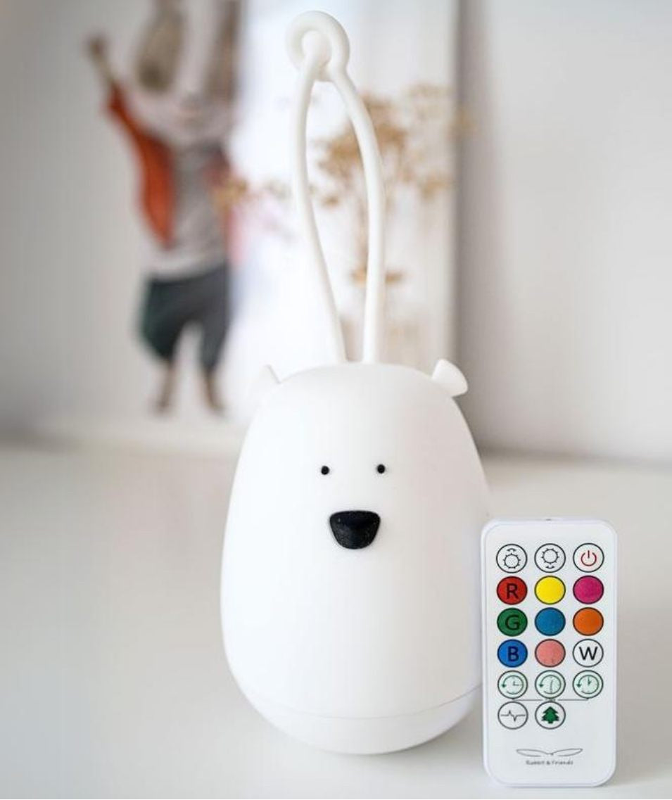 A white silicone Hanging Night Light with cartoon face and remote control. Soft, touch-friendly design for kids' safety and comfort. Features 7 colors, 12h lighting time, and USB charging.