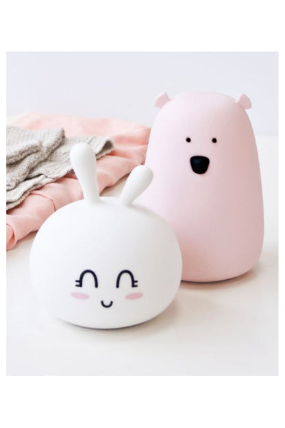 A white silicone lamp resembling a teddy bear with ears and a round belly, providing soft, touchable light for children's comfort and bedtime routines.