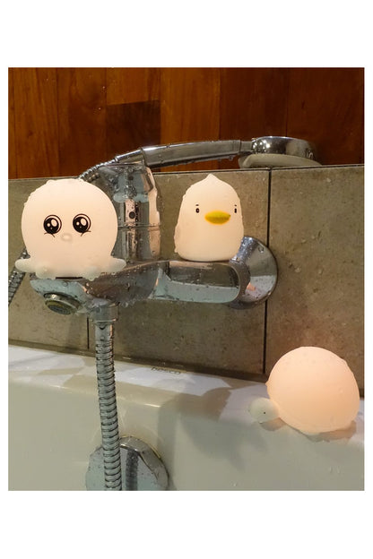 Three waterproof silicone lamps in Duck, Octopus, and Turtle shapes. Soft, touchable silicone, color-changing by tapping, and auto-off after 60 seconds. IP67 waterproof rating, 900 lighting cycles per battery.