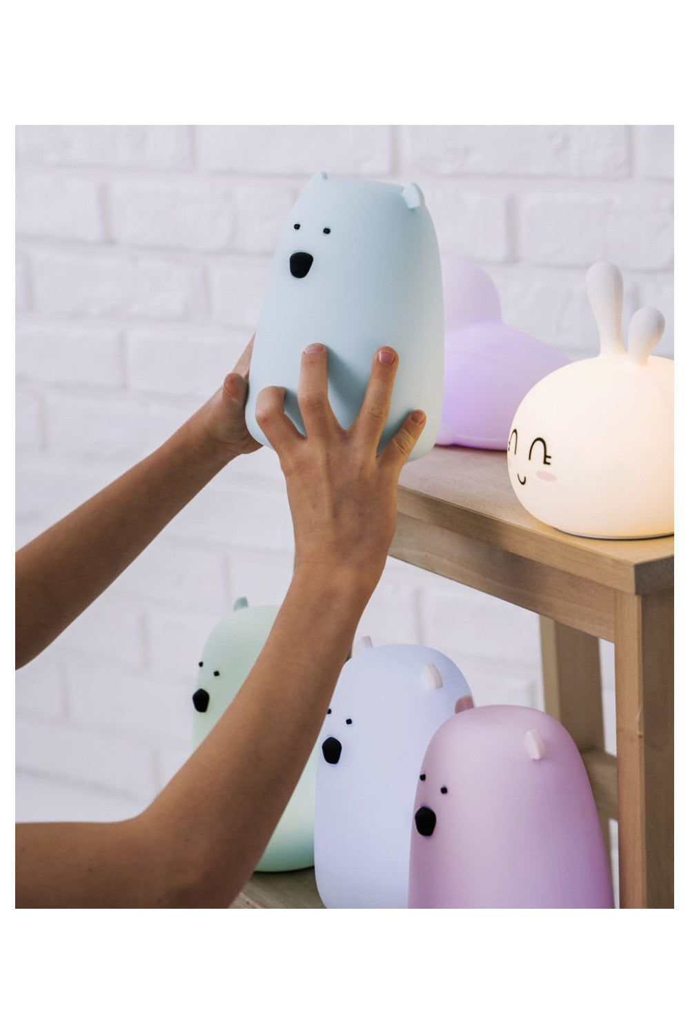 A white silicone lamp shaped like a teddy bear with protruding ears, piercing eyes, and a round belly. Soft to touch, with LED light, USB Type C power supply, and child-friendly design.