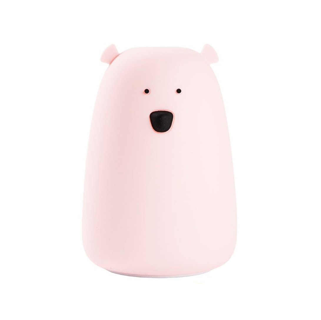 A pink silicone lamp shaped like a teddy bear with a black nose and friendly face. Soft to touch, portable, and perfect for bedtime routines. Dimensions: 16 x 10.7 x 10.7 cm.